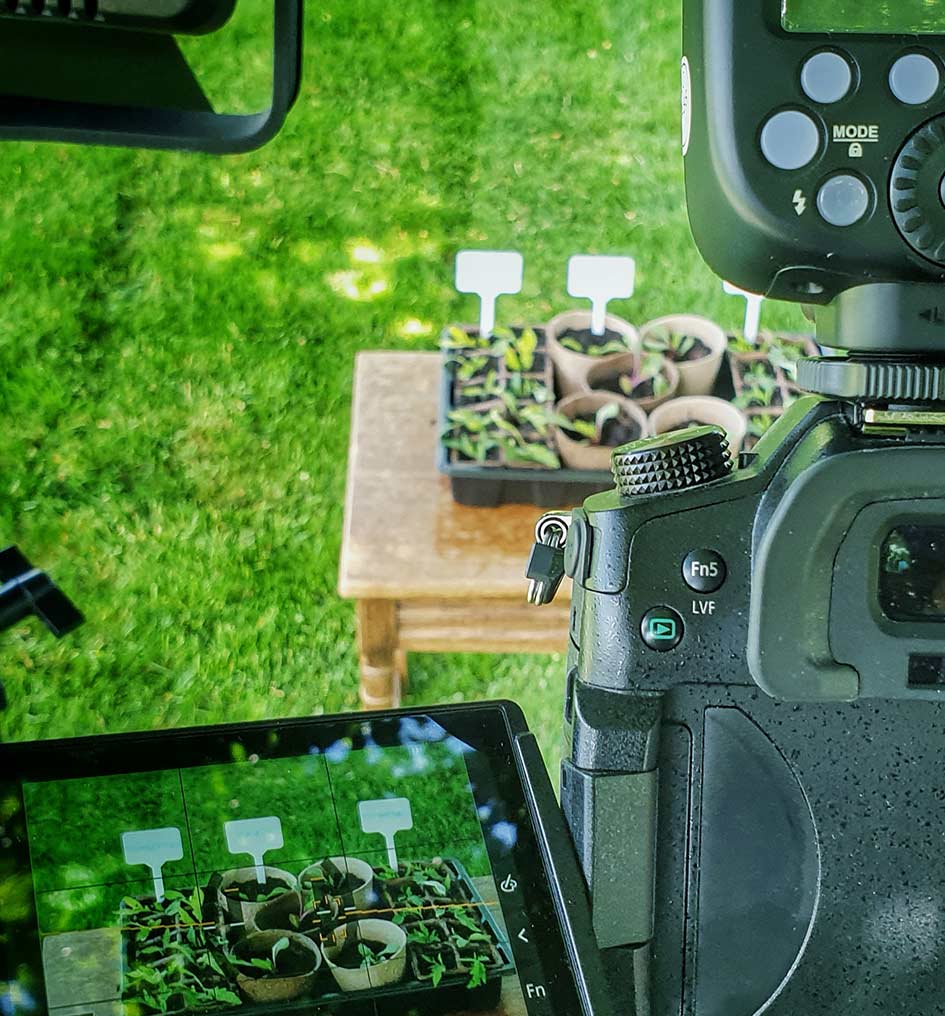 Professional camera with LCD viewfinder filming product content outdoors